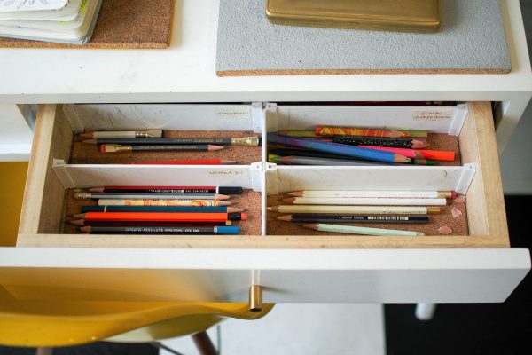 Organized drawer with labels and writing tools
